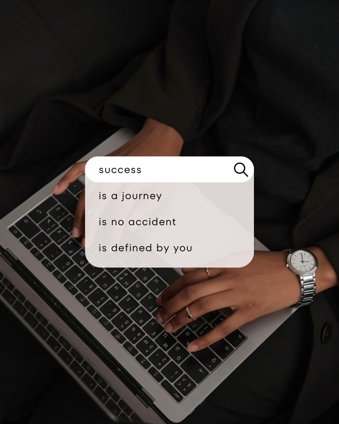 Hands typing on a laptop keyboard